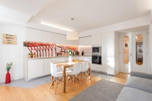 a kitchen and dining room with a table and chairs at FLH Chiado Sunny Apartment in Lisbon