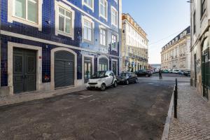 a city street with cars parked on the street at FLH Chiado Sunny Apartment in Lisbon