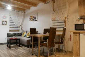 a living room with a table and a couch at Domki pod Polaną in Lesko