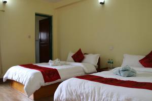 Llit o llits en una habitació de Hotel Noble Inn花椒客栈