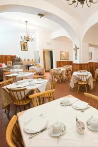 a restaurant with tables and chairs in a room at Gästehaus Deutscher Orden in Rome +21 photos