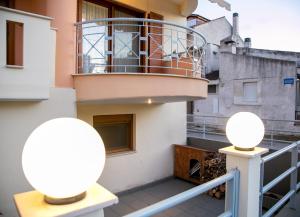 a balcony with two lights on a building at Vier Luxury House in Serres