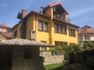 a yellow house with a balcony on top of it at Luxury Villa Medusa Temple in Kruševo