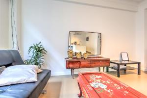 a living room with a mirror and a couch at The Meir Lodge. Apartments in heart of Antwerp in Antwerp
