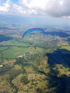 a parachute flying in the sky over a field at Luxury Villa Medusa Temple in Kruševo +15 photos