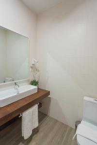 a bathroom with a white sink and a mirror at FLH Luxury Villa Mar with Private Sea Access in Caniçal