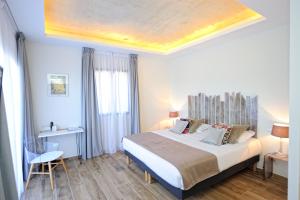 a bedroom with a large bed with a wooden ceiling at Hotel Le Tourisme in Zonza