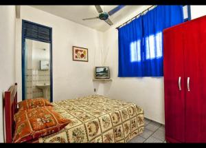 1 dormitorio con 1 cama y armario rojo en Residencial Potengy, en Natal