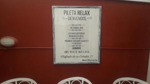 a sign for a pizza menu on a wall at Hotel Florencia in Necochea