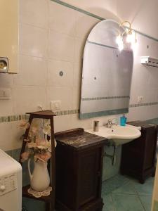 a bathroom with a sink and a mirror at Liluna in Bologna