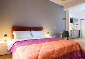 a bedroom with a large bed with a colorful comforter at Residence delle Erbe by Studio Vita in Bologna