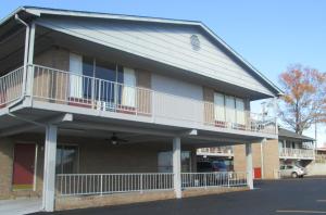 an apartment building with balconies and a parking lot at Budgetel Inn & Suites in Rockingham