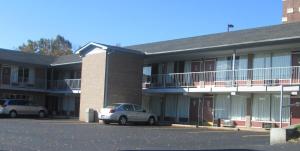two cars parked in front of a building at Budgetel Inn & Suites in Rockingham