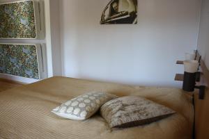 a bed with two pillows on it in a bedroom at Sankt Olof Hotell & Krog in Malung