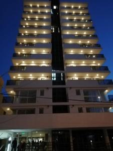 a tall building with lights on top of it at Edificio Leonardo, 5to piso in Villa Carlos Paz