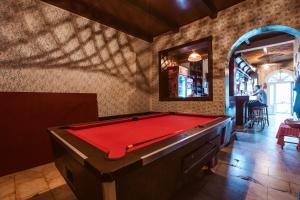 a pool table in a room with a wall at Laufer in Novi Sad