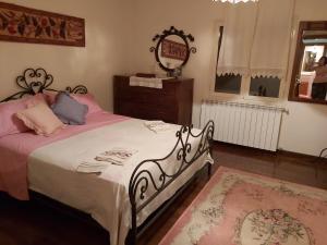 a bedroom with a bed and a dresser and a mirror at Casale Santilli in Agnone