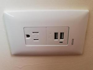 a white box with an electrical outlet on a wall at CORDIALITY INN in Puebla