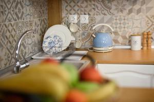 a kitchen counter with a sink and a tea kettle at Vintage Village House in Gastouri