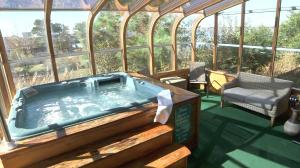 a hot tub in a house with a chair at Waterside Inn in Chincoteague