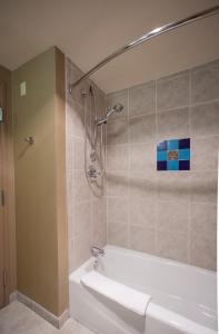a bathroom with a shower and a bath tub at Prescott Resort & Conference Center in Prescott