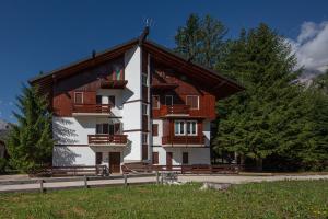 a large building with a gambrel roof at Cortina-House in Cortina dʼAmpezzo