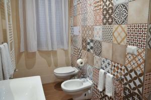a bathroom with a toilet and a sink at La Casa In Piazza in Apice +12 photos