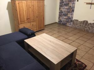 a living room with a couch and a wooden table at Haus Hennecke in Lennestadt