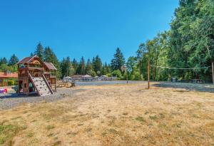a playground with a slide and a house at Chehalis Camping Resort Cottage 1 in Onalaska