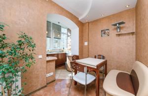 a kitchen with a table and chairs in a room at HouseHome in Kyiv +56 photos