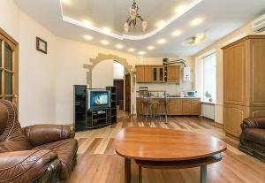 a living room with a table and a kitchen at HouseHome in Kyiv