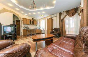 a living room with a couch and a table at HouseHome in Kyiv