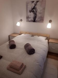 a bedroom with a bed with two towels on it at Apartman ANA in Slavonski Brod