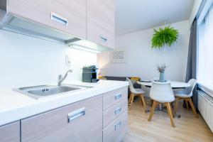 a kitchen with a sink and a table at Theaterstudio 2 Antwerp in Antwerp