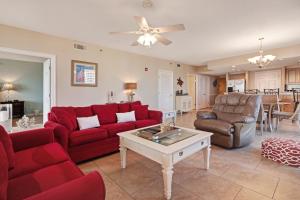 a living room with red couches and a table at Sterling Shores III in Destin