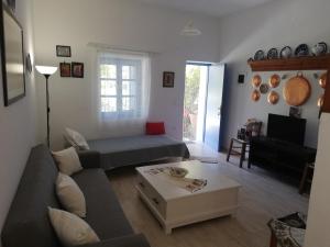 a living room with a couch and a coffee table at Blue House in Acherounes