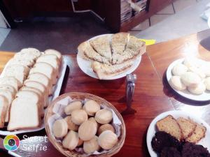 a table topped with plates of bread and pastries at Hotel Benevento in La Plata