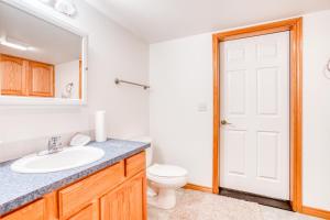 a bathroom with a sink and a toilet at Spacious Seaside Home with an Ocean View in Seaside