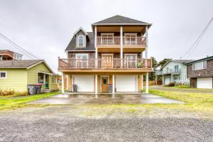 a large house with a balcony on top of it at Spacious Seaside Home with an Ocean View in Seaside