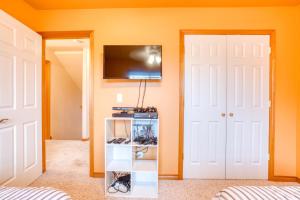 a room with two doors and a tv on the wall at Spacious Seaside Home with an Ocean View in Seaside