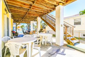 a patio with tables and chairs and a staircase at Burgundy Breeze in Tavernier