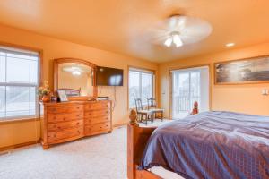 a bedroom with a bed and a dresser and a mirror at Spacious Seaside Home with an Ocean View in Seaside
