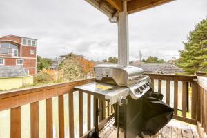 a grill sitting on a deck on a balcony at Spacious Seaside Home with an Ocean View in Seaside