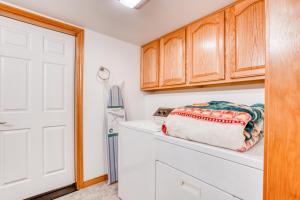 a kitchen with wooden cabinets and a white counter top at Spacious Seaside Home with an Ocean View in Seaside