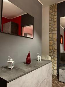 a bathroom with two tables and a mirror at La Casetta Rossa in Frosinone