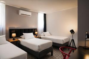 Postel nebo postele na pokoji v ubytování The PopCity Hotel