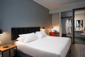 Postel nebo postele na pokoji v ubytování The PopCity Hotel