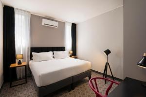 Postel nebo postele na pokoji v ubytování The PopCity Hotel