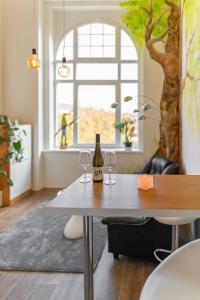 a table with two glasses and a bottle of wine at Apartmány Vila Singles in Litoměřice