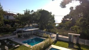 a house with a swimming pool in a yard at Divine Luxury Apartments in Toroni